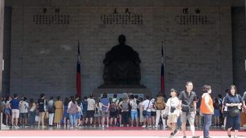 landscape view inside Chiang Kai Shek Memorial hall area with crowded people watching The changing of the guard ceremony through the giant main gate video