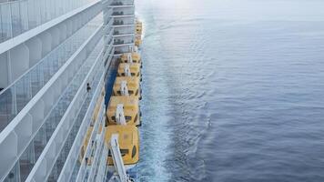 view to the back aft of the cruise ship from front deck area with side view of the passenger cruise ship while cruising in the sea in day time with many lifeboats video