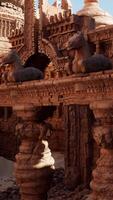 A group of statues displayed on a wooden table in a temple video