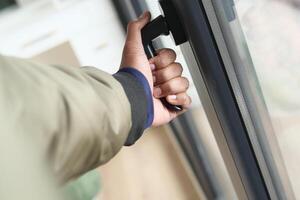 hand open gray plastic pvc window at home at early morning photo