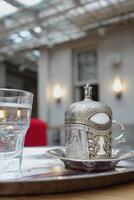 a cup of turkish coffee on table photo