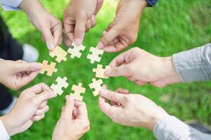 Coworker's hand holding jigsaw puzzle With the cooperation of business people team joins together to campaign Environment, Society and Corporate Governance. Sustainable corporate social, environmental photo