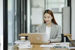 Woman sitting at work on a casual day with coffee. photo