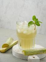 Fresh sugar cane juice or Es Tebu in glass. Indonesian drink. photo