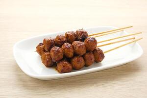 Grilled meatballs skewers with teriyaki sauce photo