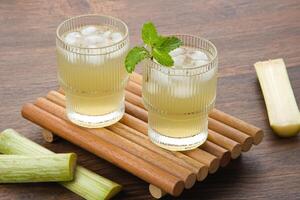 Fresh sugar cane juice or Es Tebu in glass. Indonesian drink. photo