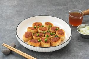 Gohyong or Ngo Hiang, made from minced chicken with flour, served with sour sauce photo