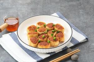 Gohyong or Ngo Hiang, made from minced chicken with flour, served with sour sauce photo