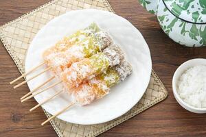 Sentiling or ongol-ongol, Indonesian traditional snack, made from cassava sprinkled with grated coconut photo