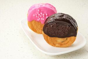 Cromboloni or Crombolini, croissant bomboloni pastry filling with chocolate paste photo