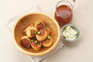 Gohyong or Ngo Hiang, made from minced chicken with flour, served with sour sauce photo