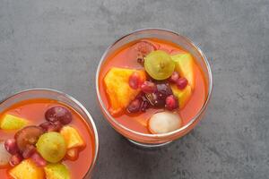 Asinan Buah or pickled fruit, Indonesian dessert made from preserved tropical fruits. Spicy, sweet and sour taste. photo