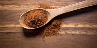 AI Generated Natural Cooking Powder In Wooden Spoon. Coriander Ground Pile. Organic Seasoning On Wooden Table. Top View Of Aromatic Spice. photo