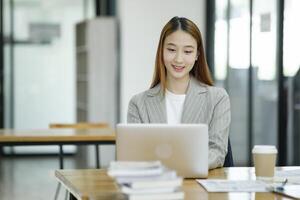 Woman sitting at work on a casual day with coffee. photo