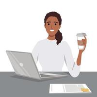 A woman is sitting on the desk and working on a laptop with coffee in one hand vector