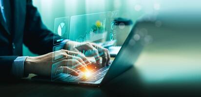 Businessman using laptop and analyzing economic growth, financial graph and business investment. planning strategy, stock market statistics, stock market trends, technical analysis strategy, value photo