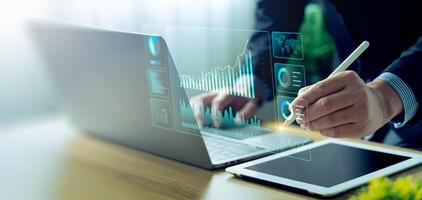 Businessman using laptop and analyzing economic growth, financial graph and business investment. planning strategy, stock market statistics, stock market trends, technical analysis strategy, value photo