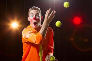 Circus clown performs number. Clown man juggles photo