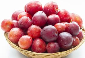 A lot of plums closeup on a white background photo