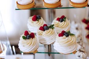 Candy bar at a wedding. Delicious desserts. Beautiful decorations. Fruits. Sweet cakes on your holiday. Birthday. Sweet life. photo