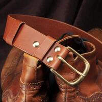 Part of a brown belt made of genuine expensive leather. photo