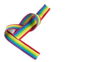 Colorful rainbow ribbon closeup isolated on white background. Colorful LGBT design. Curly, fluttering ribbon. photo