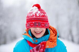 Happy little boy with a snowy hat. Happy winter holidays concept. photo