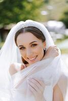 Beautiful bride with wedding flowers bouquet, attractive woman in wedding dress. Happy newlywed woman. Bride with wedding makeup and hairstyle. Smiling bride. Wedding day. Gorgeous bride. Marriage. photo