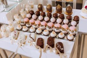 Candy bar at a wedding. Delicious desserts. Beautiful decorations. Fruits. Sweet cakes on your holiday. Birthday. Sweet life. photo