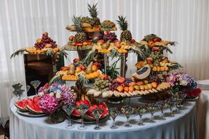 Fruit buffet for a wedding. Assortment of exotic fruits in the restaurant. Various compositions from fresh fruits. photo