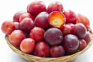 A lot of plums closeup on a white background photo