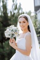 Beautiful bride with wedding flowers bouquet, attractive woman in wedding dress. Happy newlywed woman. Bride with wedding makeup and hairstyle. Smiling bride. Wedding day. Gorgeous bride. Marriage. photo