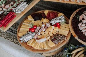 Meat and cheese snacks on the buffet. A buffet in a closed room, at a wedding celebration or birthday. Sandwiches on skewers before the start of the holiday. photo