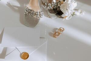 Bride's engagement ring, stilettos, Perfume. Wedding details of the bride. Flowers Beautiful light. wedding dress photo