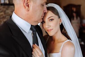 A beautiful bride with her father on her wedding day. The best moments of the wedding day. Daughter and father. photo