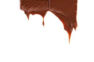 Piece of melted chocolate bar isolated on white background. Chocolate drips. photo