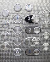 Metal elevator panel with buttons and numbers. photo