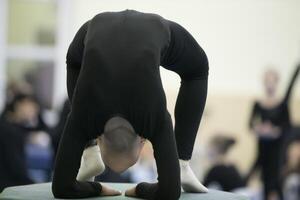 Gymnastic workout. Girl with a flexible body photo