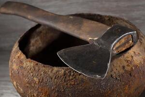 Ax on an old rusty bowler. photo