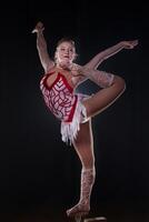 Circus actress performs the number in a beautiful smoke. Manual equilibrium on canes. Flexible girl body.Performance of an air gymnast in a circus photo