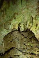 The cave is karst, amazing view of stalactites and stalagnites illuminated by bright light, a beautiful natural attraction in a tourist place. photo