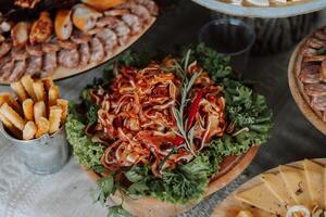 Meat and cheese snacks on the buffet. A buffet in a closed room, at a wedding celebration or birthday. Sandwiches on skewers before the start of the holiday. photo