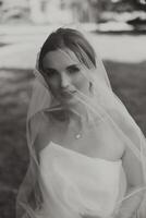 portrait of a beautiful young bride in a white dress with a long veil and a gorgeous hairstyle. Smiling bride. Wedding day. Gorgeous bride. Marriage. photo