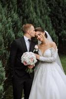 The bride is dressed in an elegant lush white wedding dress with a long veil and is ready for her groom. The first meeting of the bride and groom photo