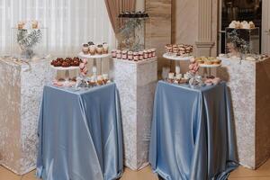 Candy bar at a wedding. Delicious desserts. Beautiful decorations. Fruits. Sweet cakes on your holiday. Birthday. Sweet life. photo