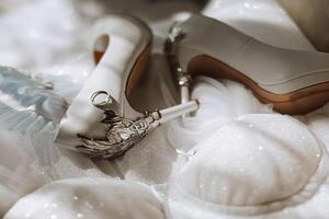 Bride's engagement ring, stilettos, Perfume. Wedding details of the bride. Flowers Beautiful light. wedding dress photo