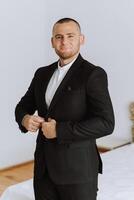 Man fastens the buttons. The groom in a suit. Close up. Man is buttoning his vest. Perfect to the last detail. Modern businessman. photo