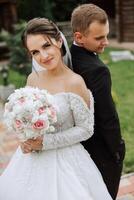 Happy couple celebrating their wedding outdoors. Amazing smiling wedding couple. Pretty bride and stylish groom. Wedding portrait. photo