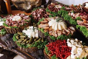 Meat and cheese snacks on the buffet. A buffet in a closed room, at a wedding celebration or birthday. Sandwiches on skewers before the start of the holiday. photo