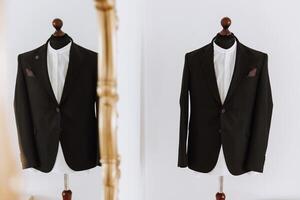 black men's suit. The man is ready to wear a business suit, white shirt and tie. A black jacket on a mannequin photo